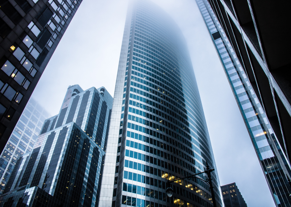 A cluster of tall glass skyscrapers in dense urban environment. 