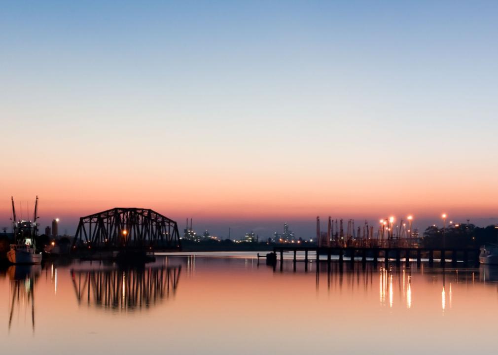 A bridge over a body of water at sunset. 