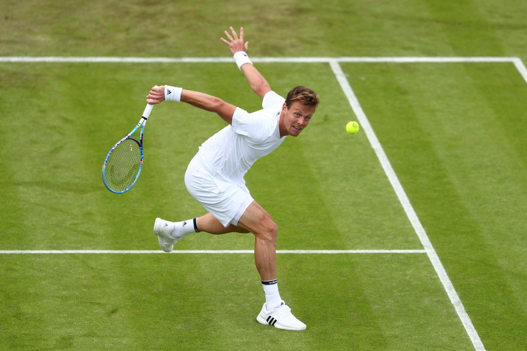 Tomas Berdych of The Czech Republic playing a backhand during the Men's Singles first round match against Ivan Dodig of Croatia on day two of the 2016 Wimbledon Lawn Tennis Championships 