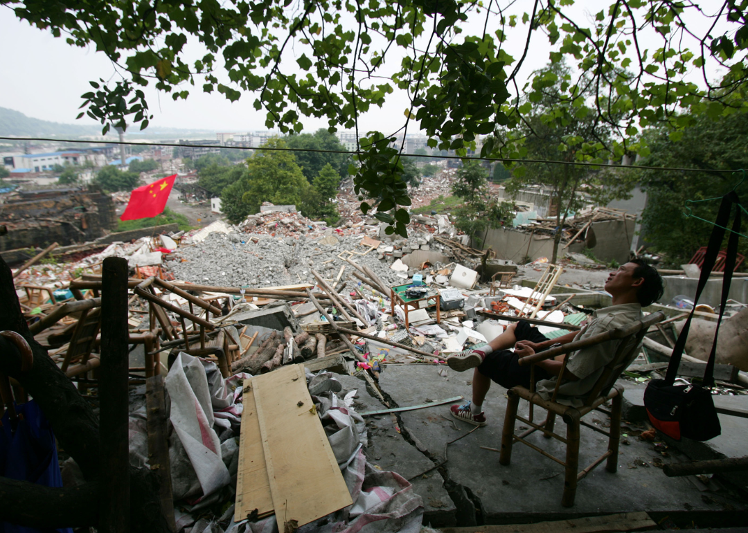 A man rests near earthquake debris in Mianzhu of Sichuan Province, China. 
