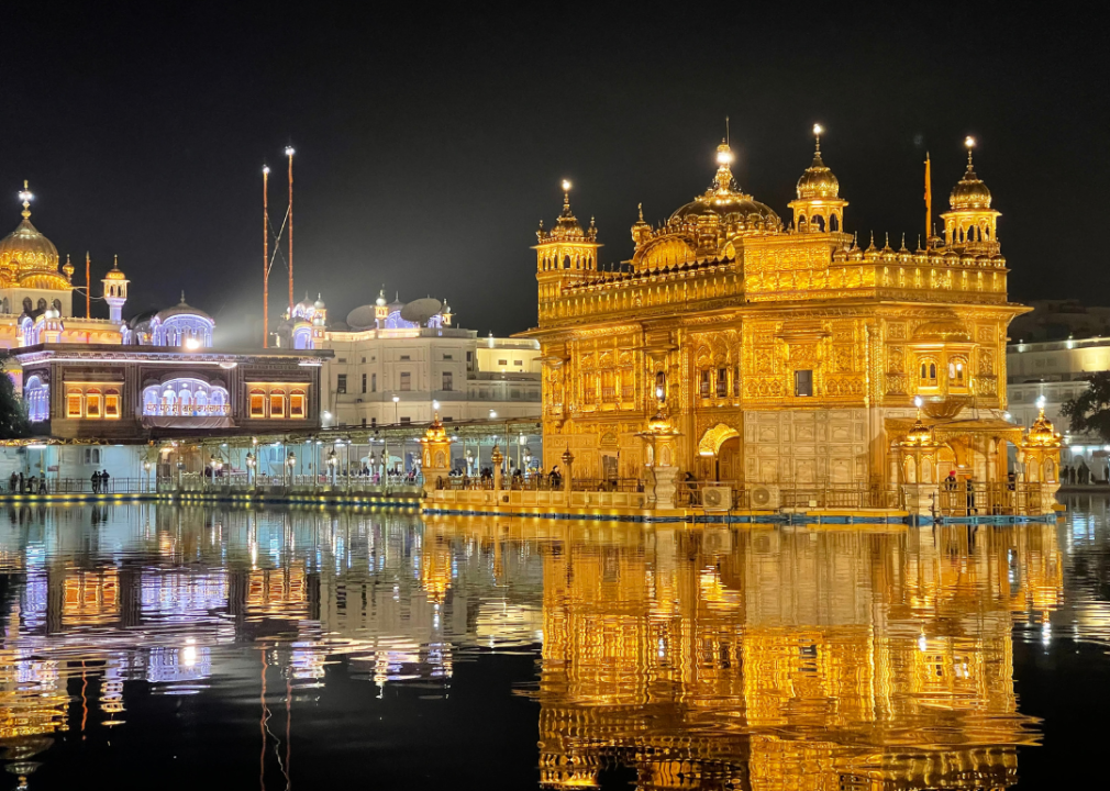 Golden temple lit up at night.