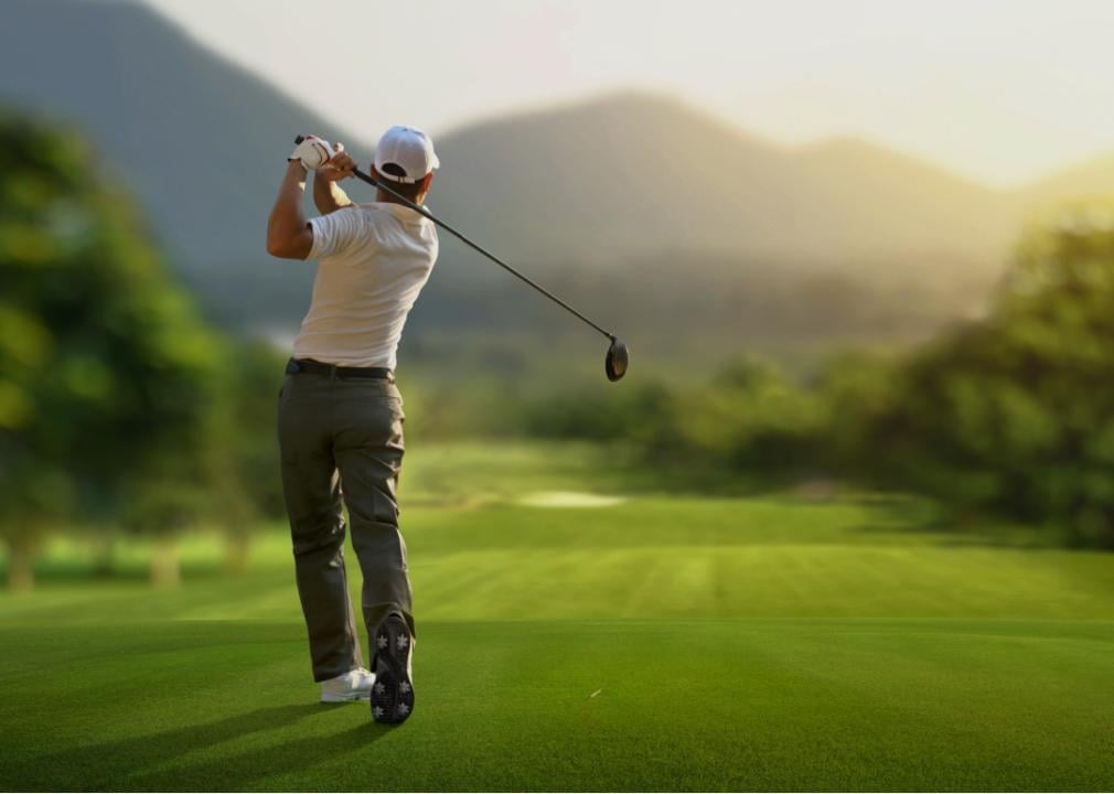 A golfer on a green golf course.