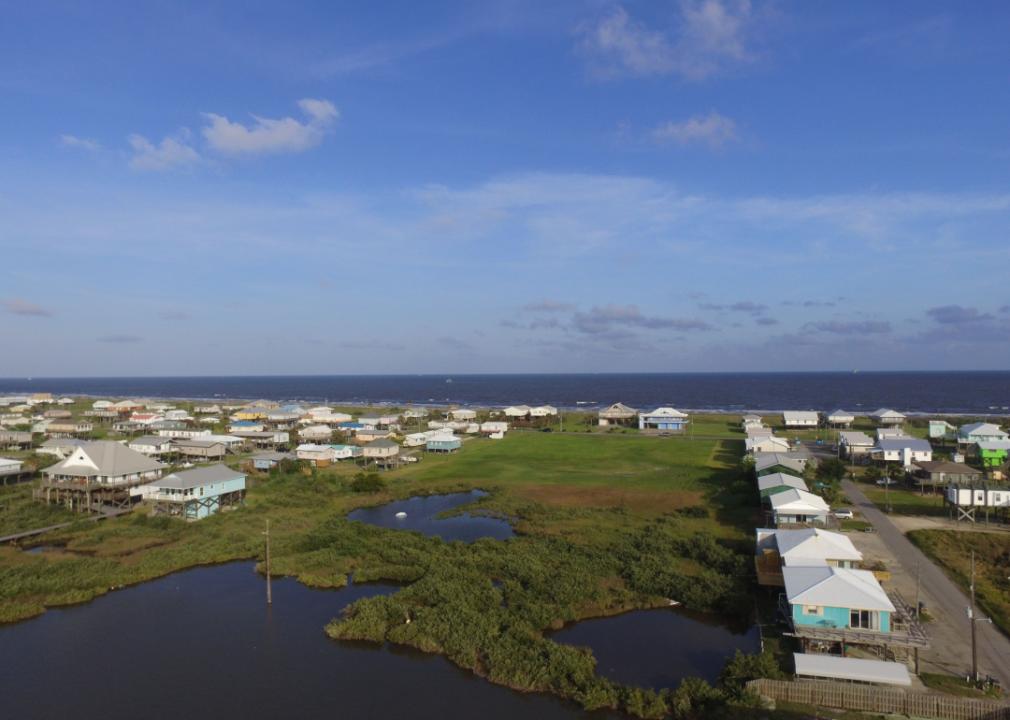 An aerial view of a residential area near the ocean. 