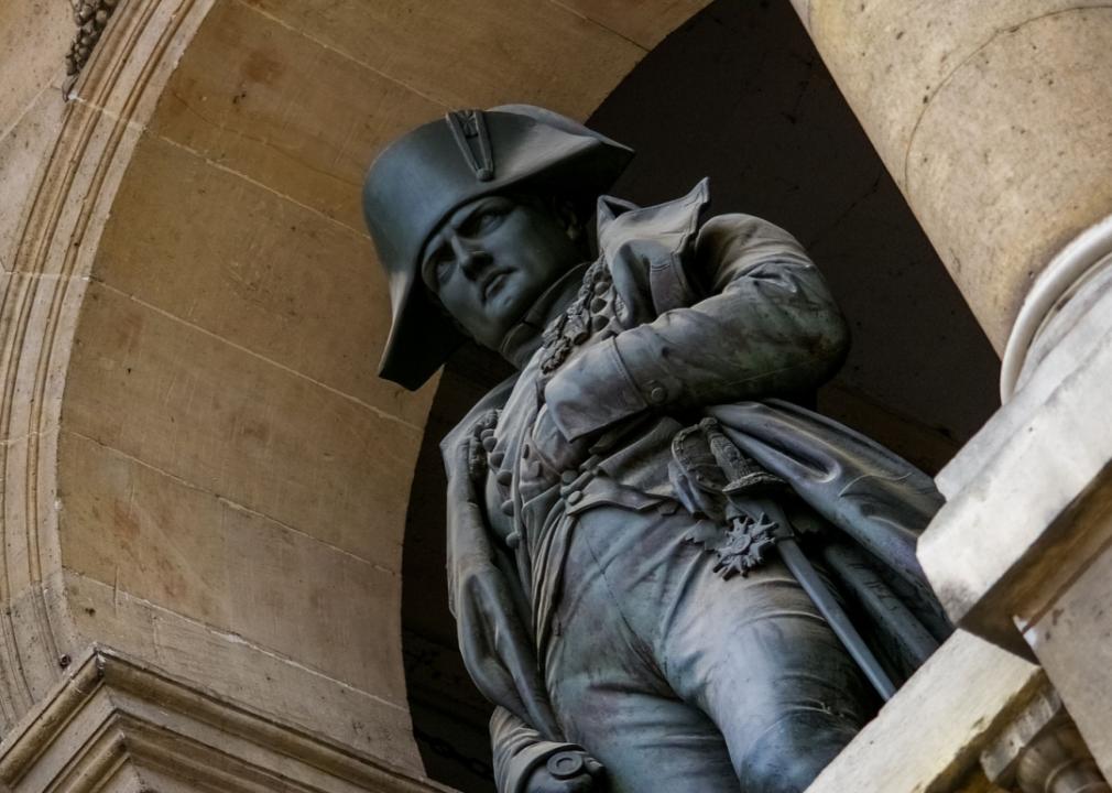 A statue of a military person standing in the arch.