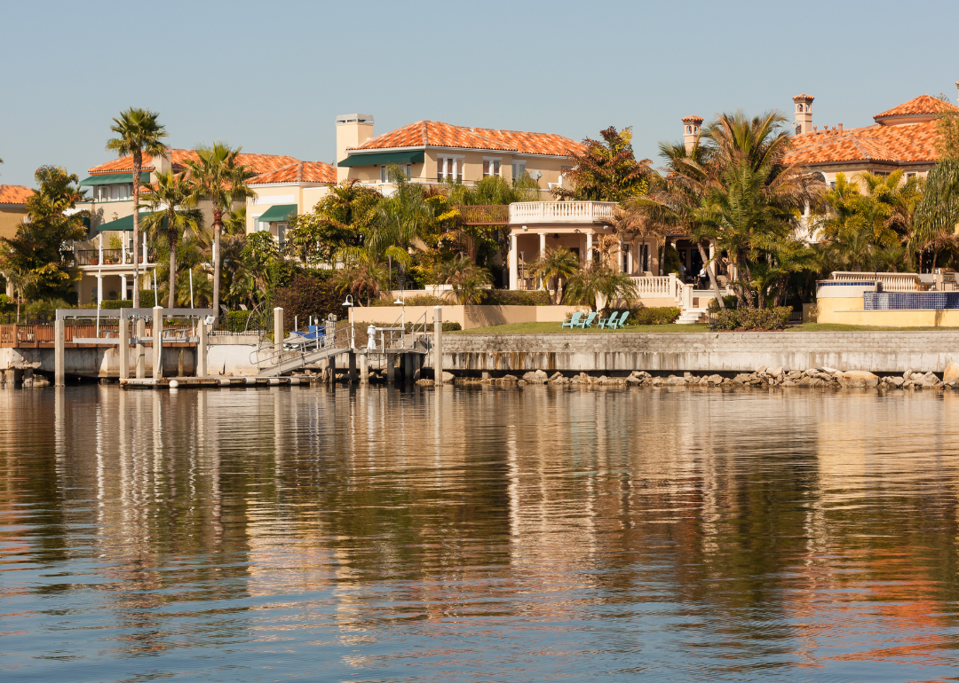 Large stucco homes on the water.