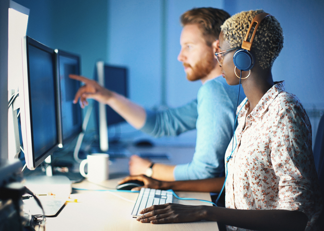 Two people working in front of computers.