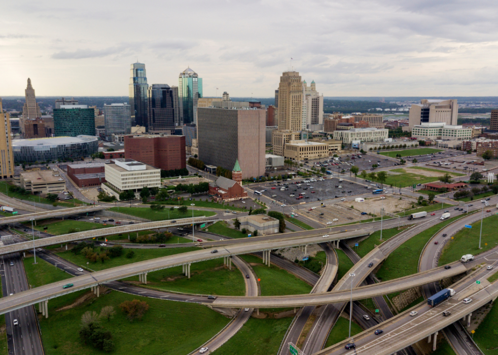 An aerial view of highways with the city skyline.
