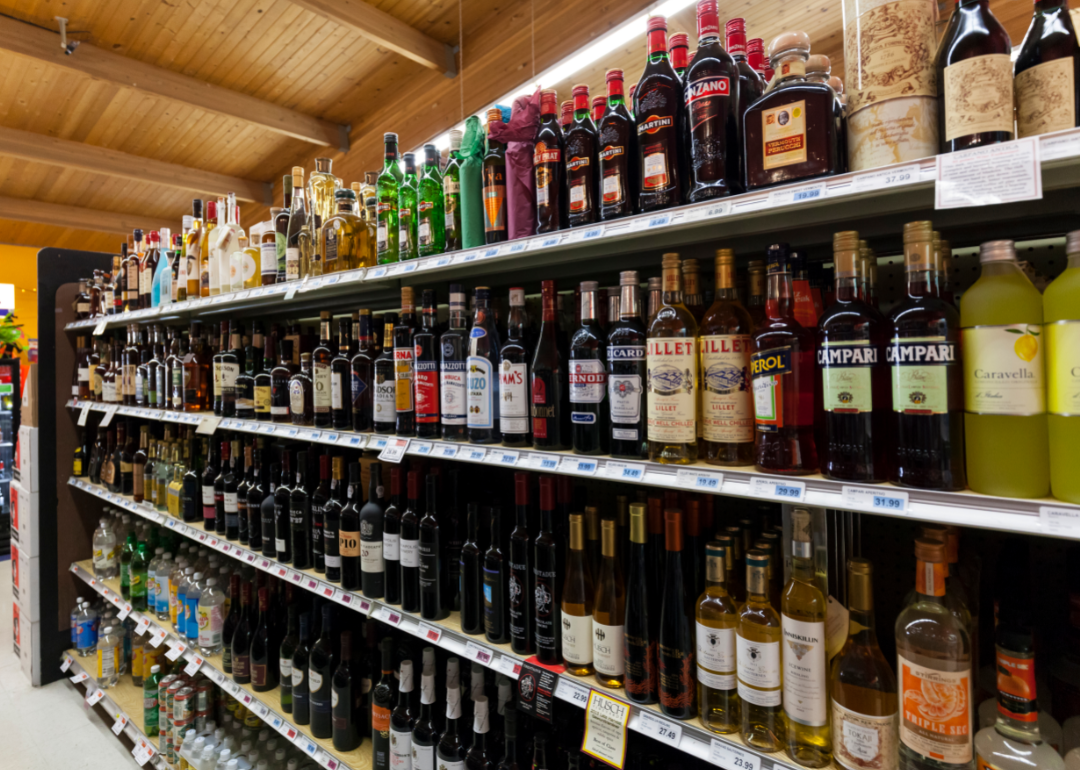 A variety of bottles on shelves in a liquor store