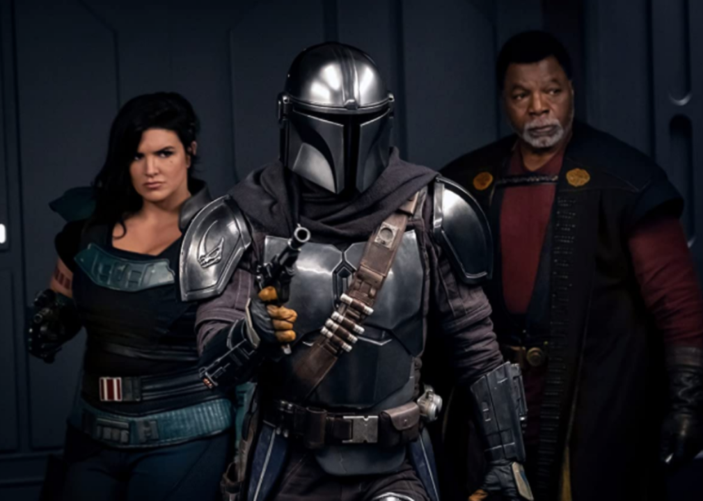Three actors pose in a scene from ‘The Mandalorian.’