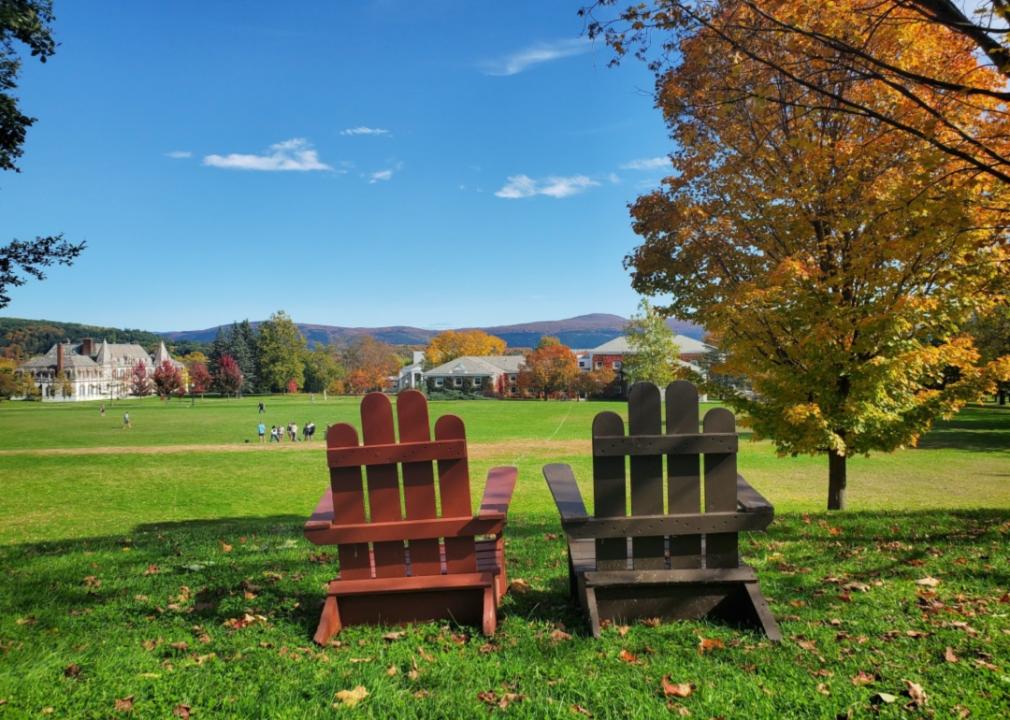 #40. Middlebury College Two adirondack chairs overlooking Fall foliage at Middlebury College.