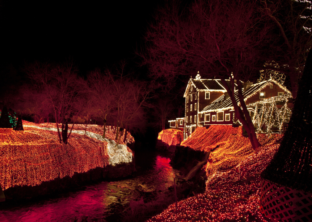 Clifton Mill and riverbank light up with holiday lights.