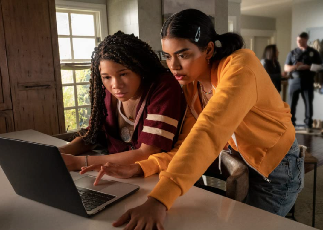 Megan Suri and Storm Reid looked at a laptop with concerned faces in Missing.