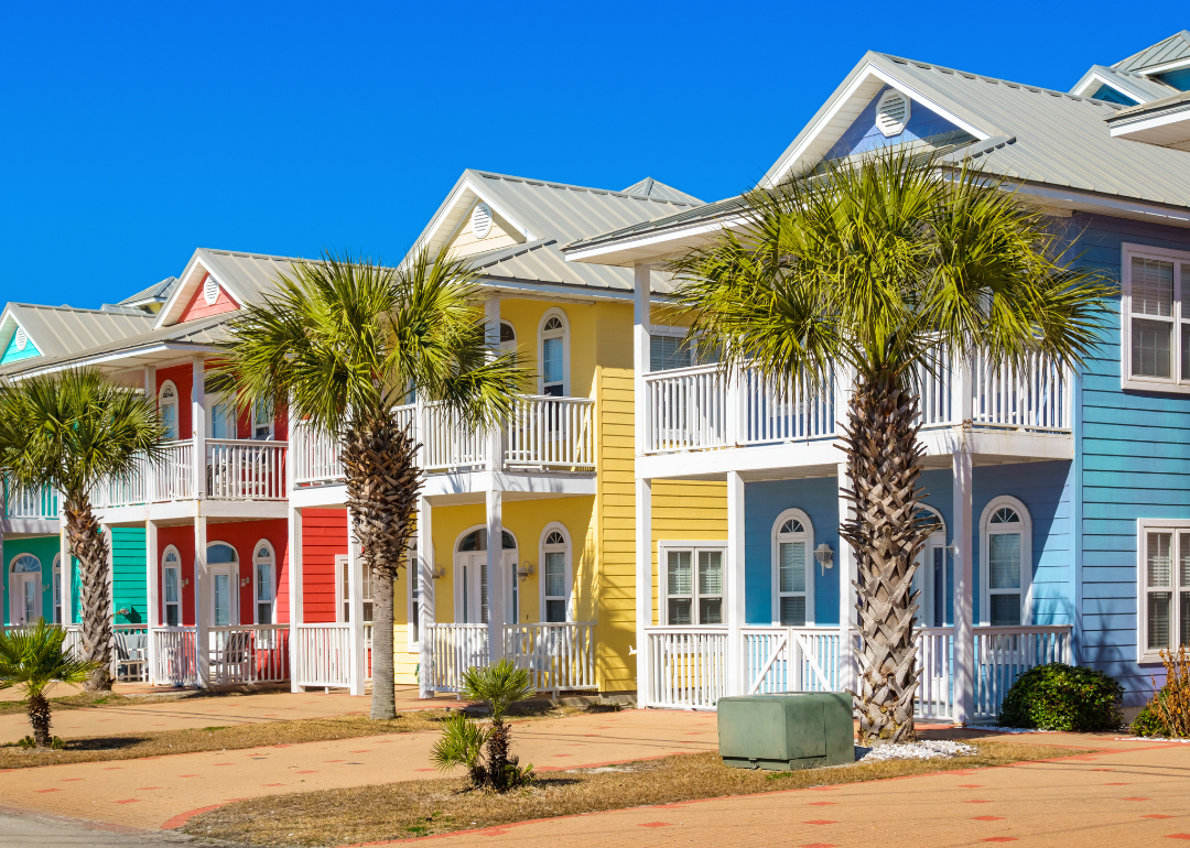 Colorful houses lined with palm trees in Panama City Beach.