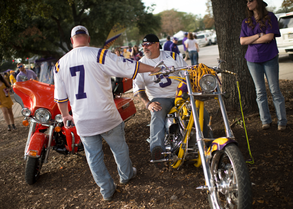 Two guys with motorcycles talking before a football game in Baton Rouge, Louisiana.