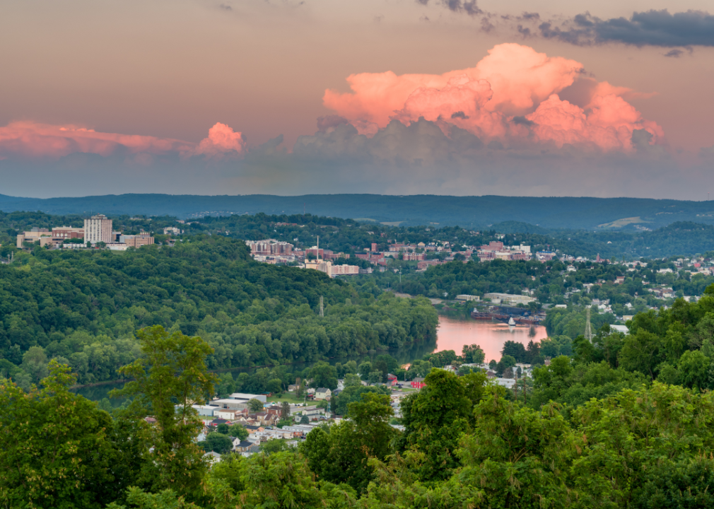 An aerial view of Morgantown, WV nestled in the trees at sunset.