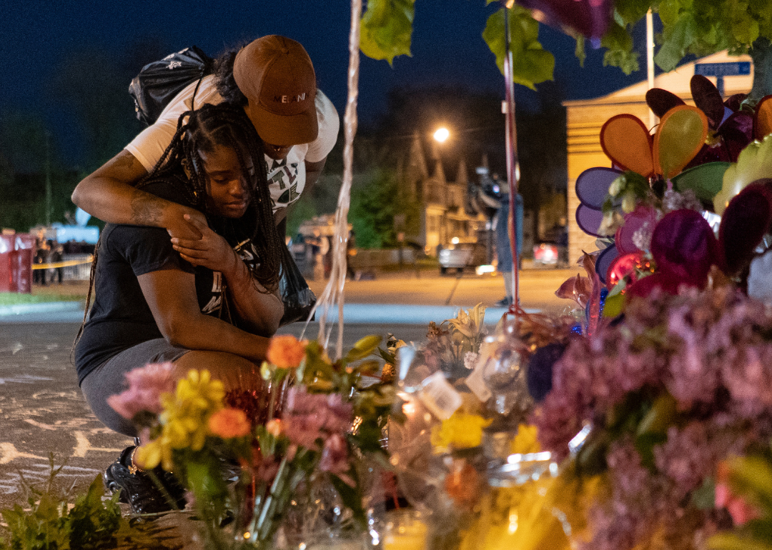 Two mourners visit a memorial in remembrance of the Buffalo mass shooting.