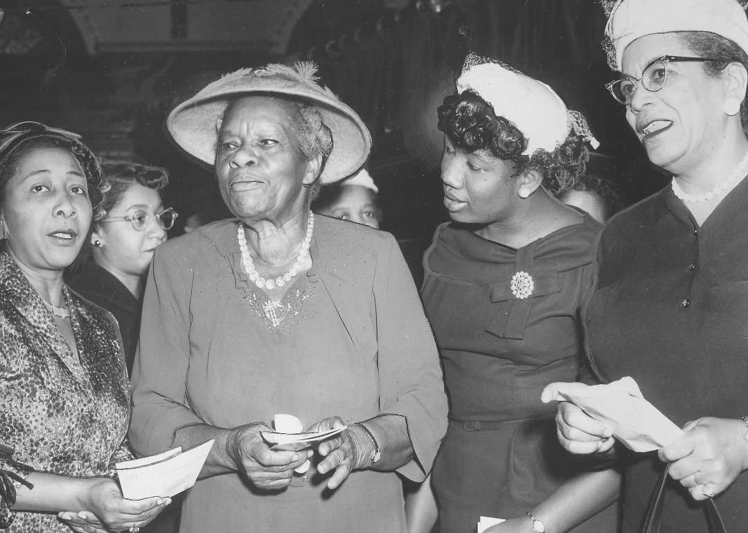 Nannie Helen Burroughs, flanked by other women, at Annual Woman