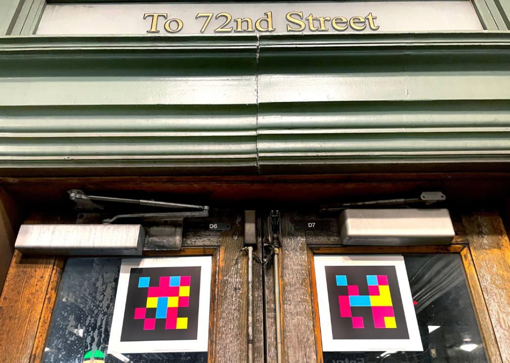 NaviLens, a colorful QR code, displayed on the doors of the entrance to the 72nd Street subway station in New York City. 