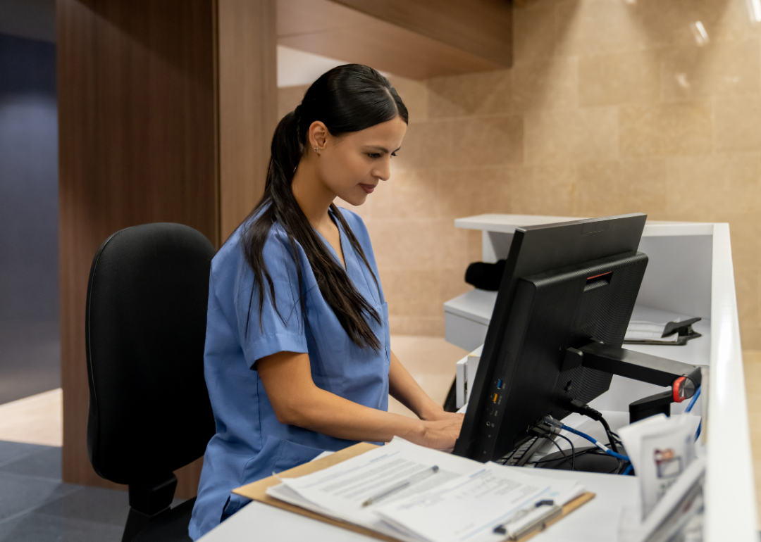 A nurse working on a computer.
