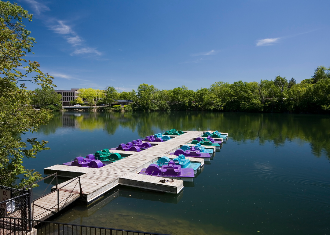 Paddleboats parked at a dock on the water.