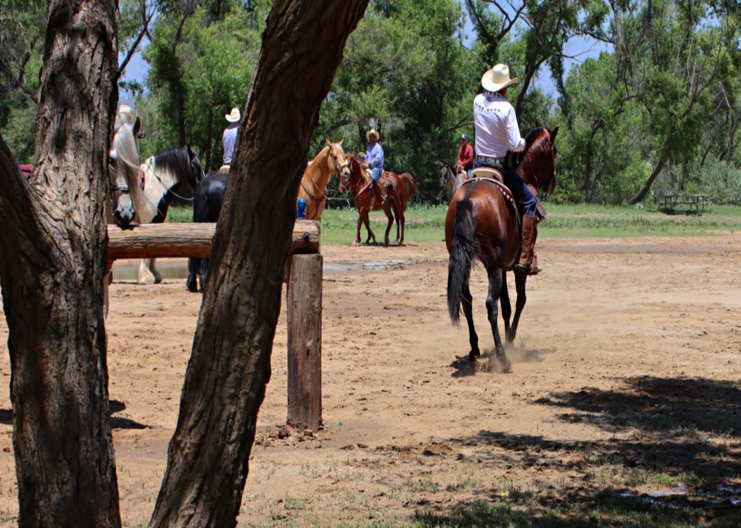 People on horses in an arena.