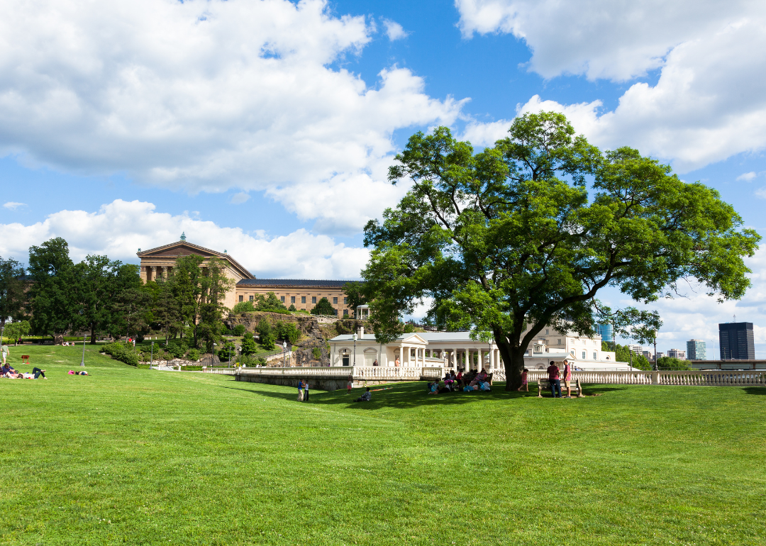 People on the lawn at an art museum park.