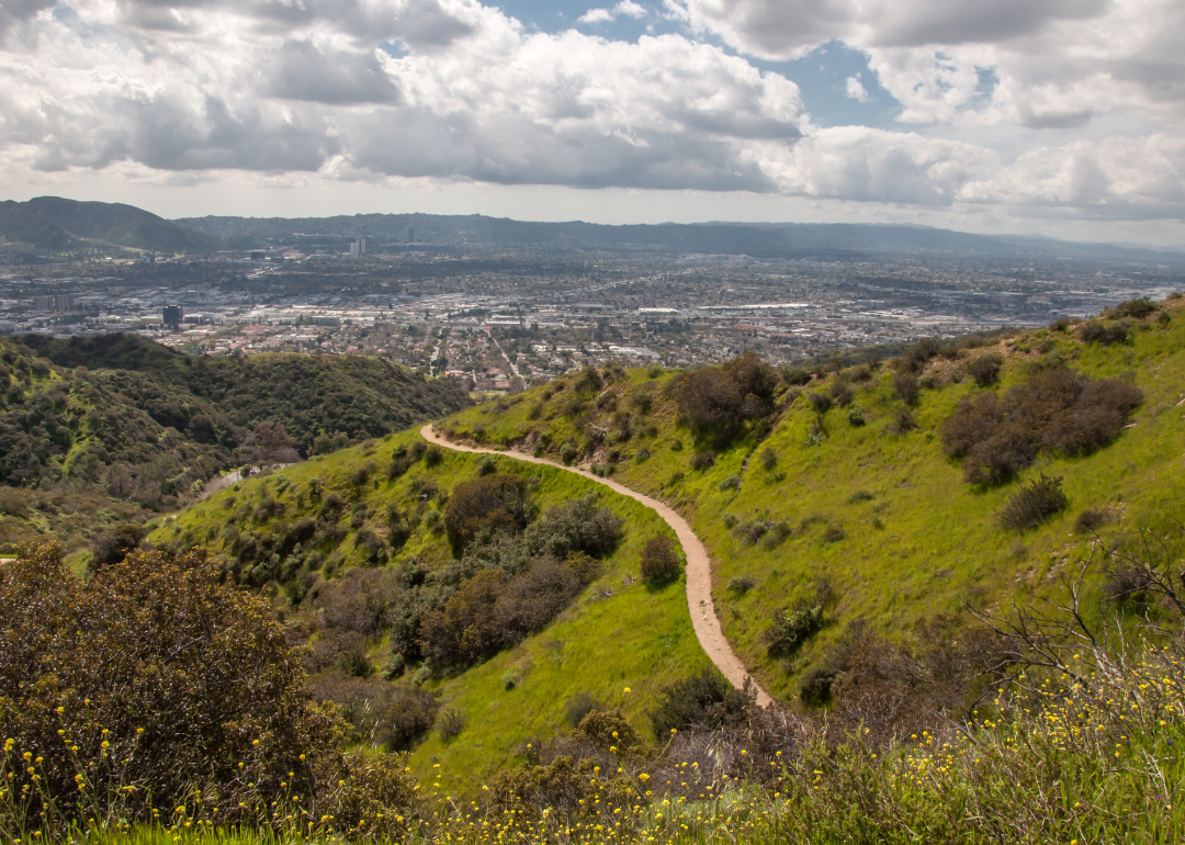 A trail in the hills with Burbank in the background.