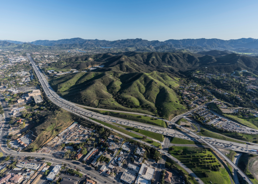 An aerial view of Thousand Oaks and a highway in the foothills.