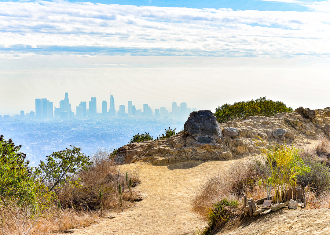 A hiking trail vista with Los Angeles in the background.