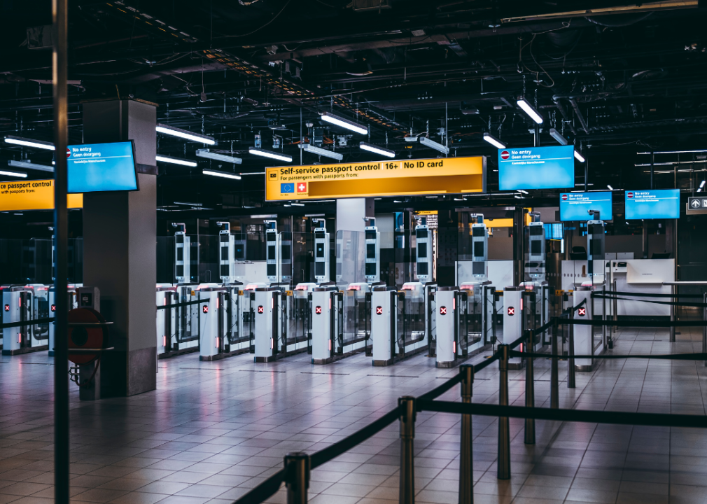 A row of automated border control e-gates at an airport.