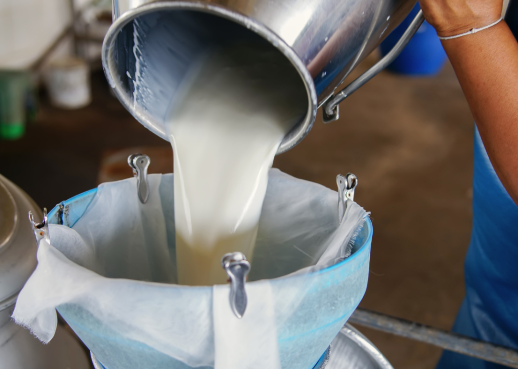 Raw milk being poured into a bowl.