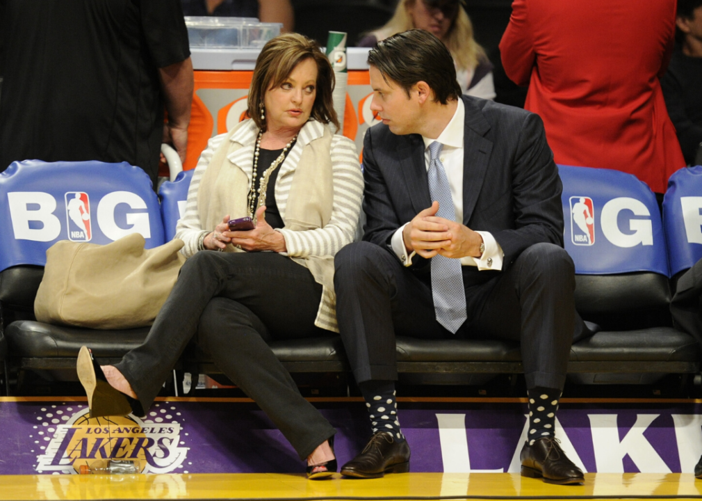Ann and Josh Kroenke chat at a NBA playoff game.