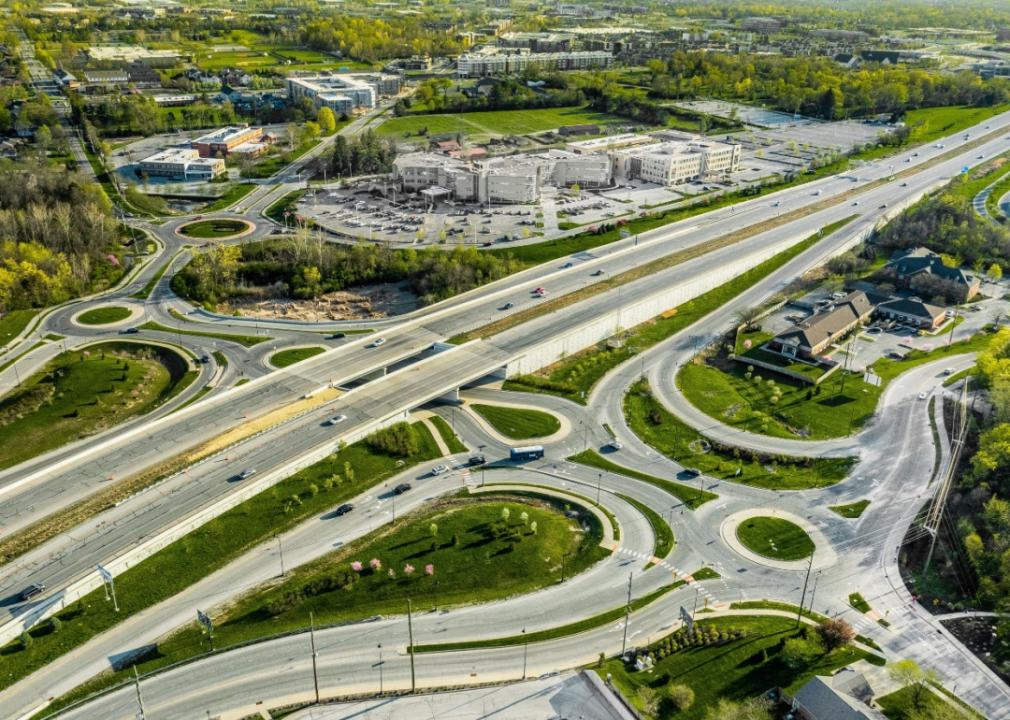 A drone view of a group of roundabouts and a highway.