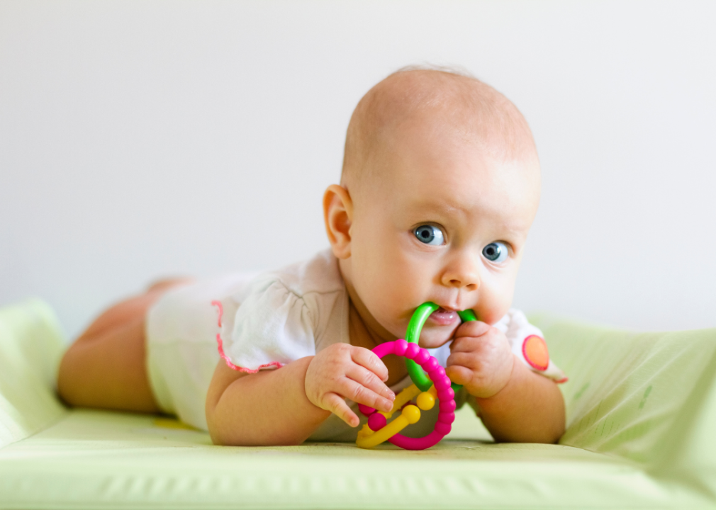 A baby girl with teething ring. 