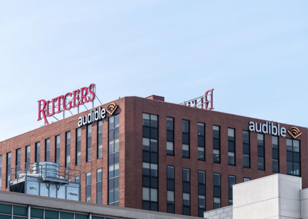 A large brick modern building with a sign that says Rutgers in red and audible in white. 