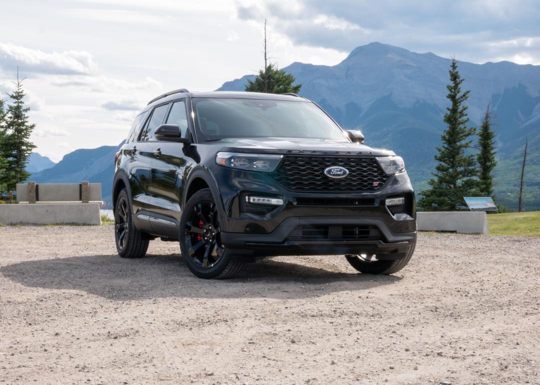 A black Ford Explorer with mountains in the background.