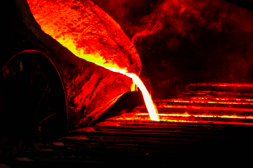 Bright red and orange molten material being poured. 