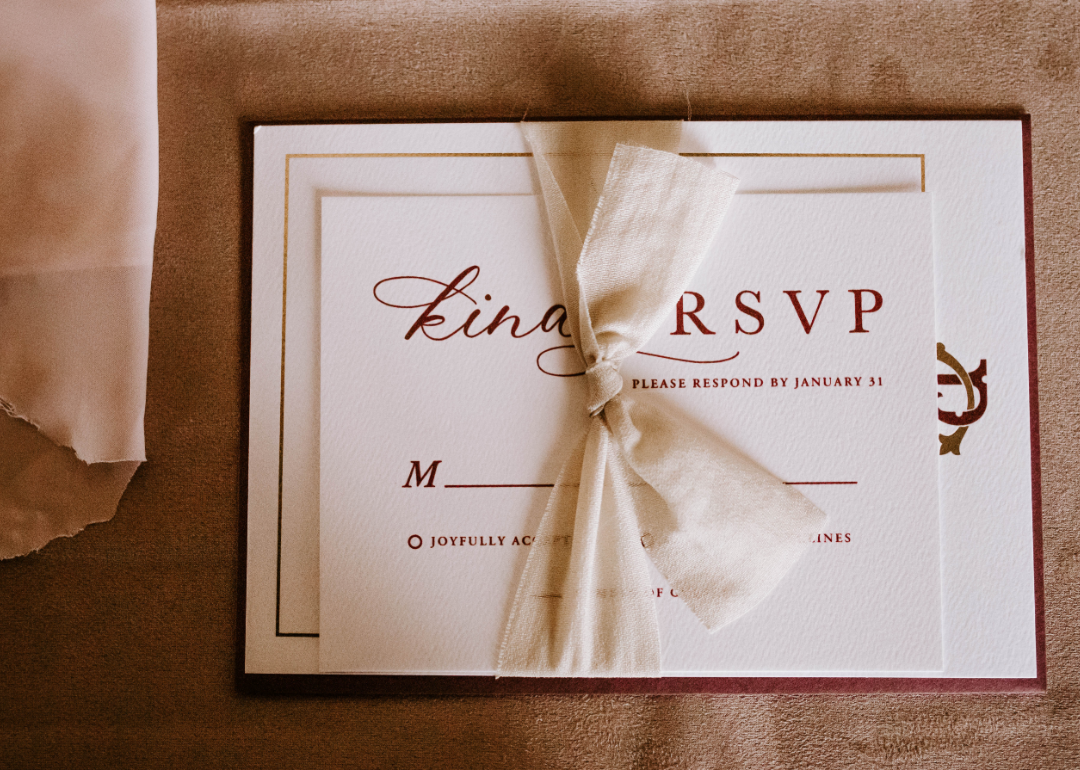 A bridal shower invitation requesting RSVP tied with a ribbon.