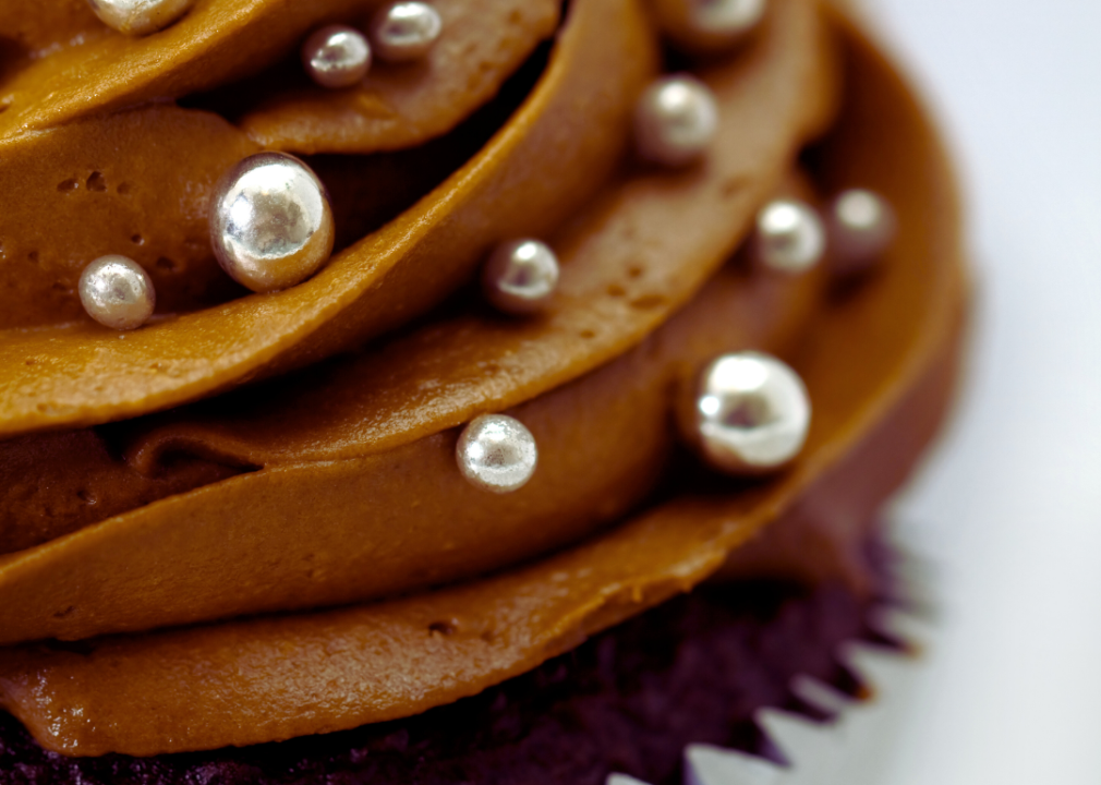 A chocolate cupcake decorated with silver dragees.