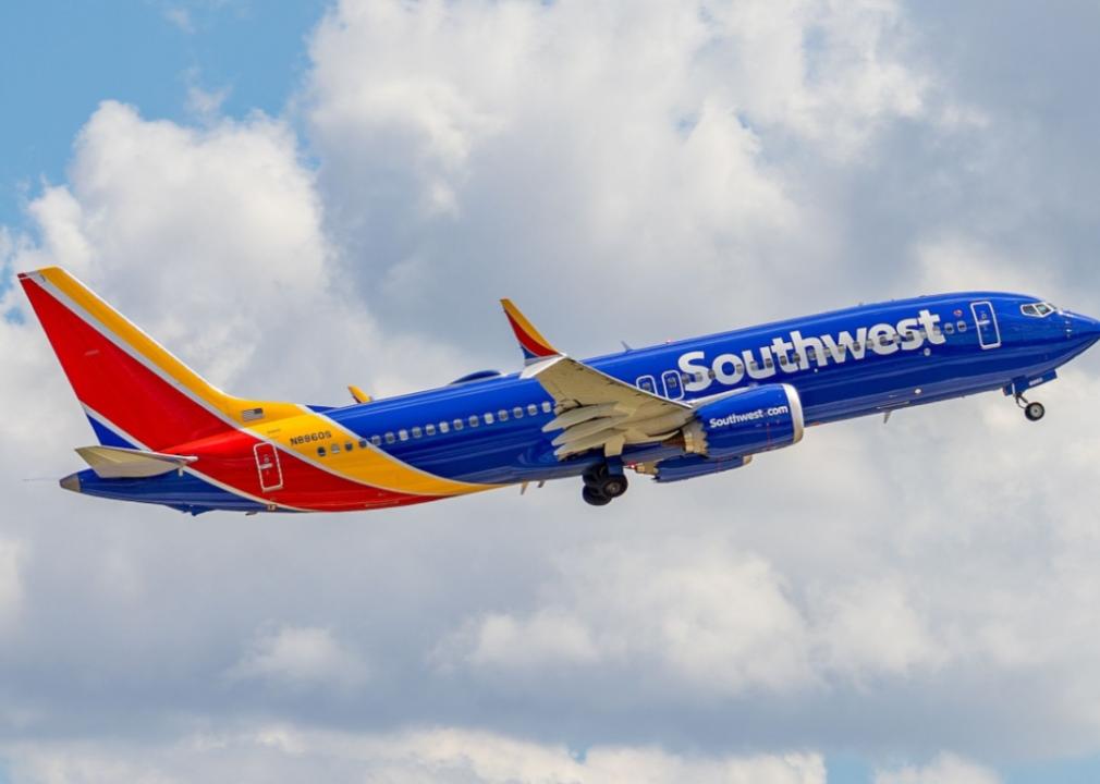 A Southwest Airlines airplane in flight against blue skies. The plane is painted in the airline