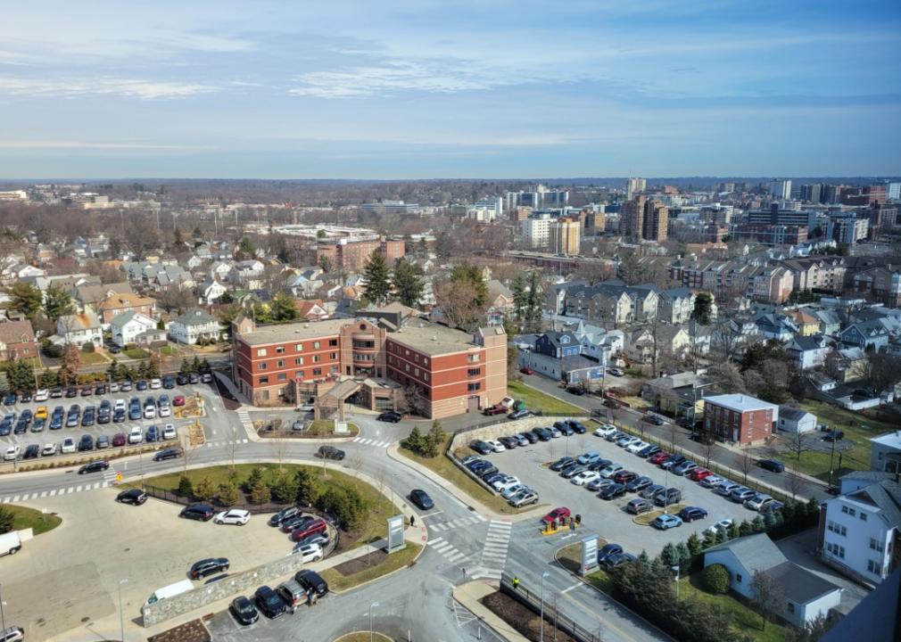 An aerial view of a city with a large red brick building in the center.