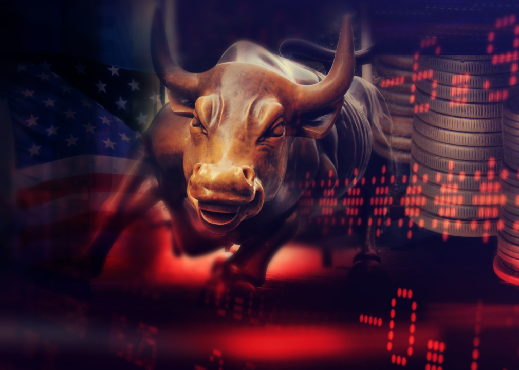A stock market bull bronze statue with a background of financial charts.