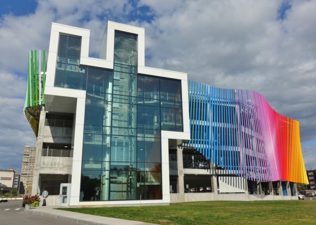 The exterior of the Strong National Museum of Play, which has a bright rainbow colored structure wrapping around it.