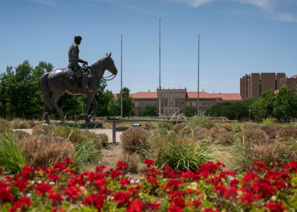 A statue of a man on a horse in front of Texas Tech.