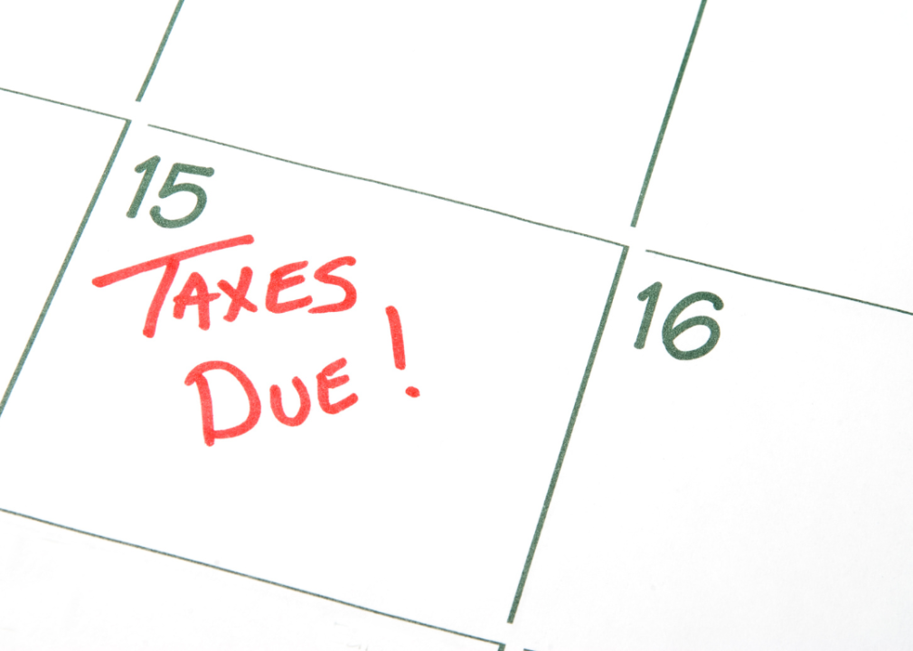 A close up of a calendar with number 15 with red writing "taxes due" with exclamation mark.