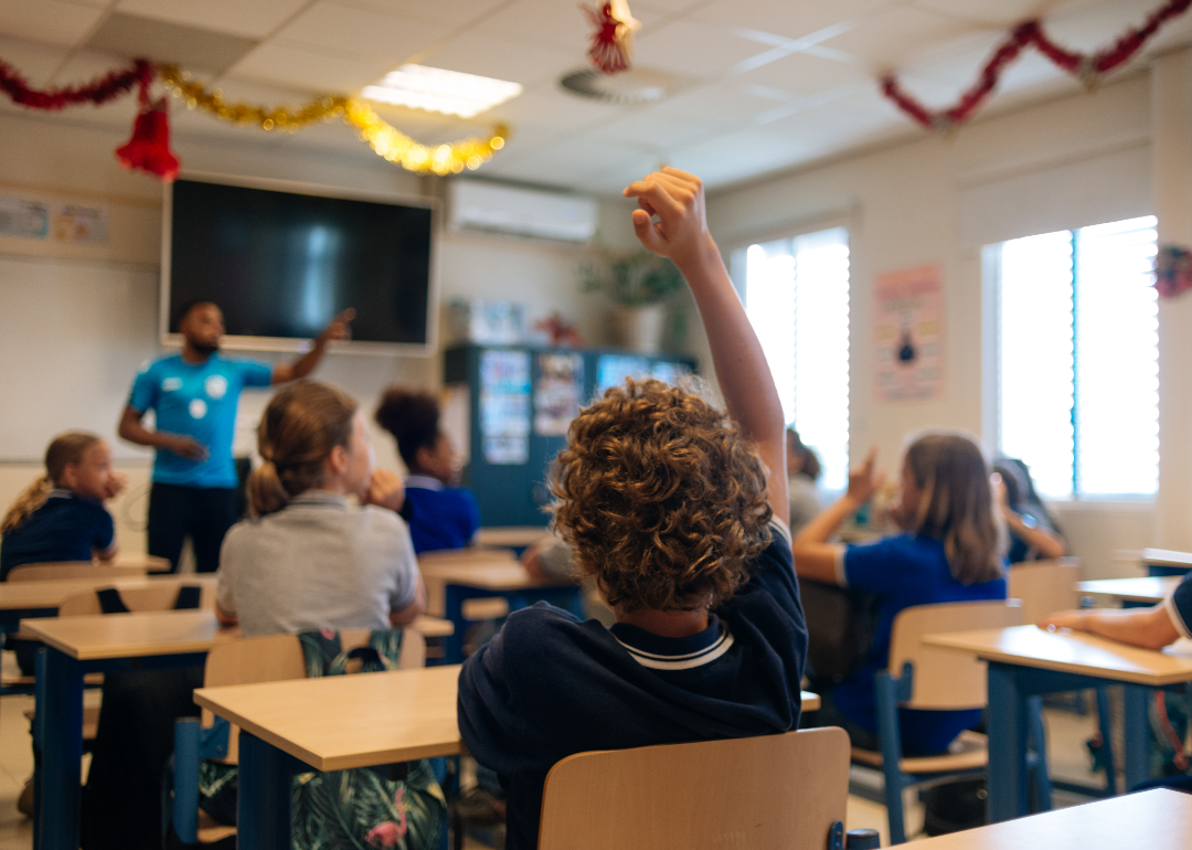 A teacher addresses his students in a classroom.