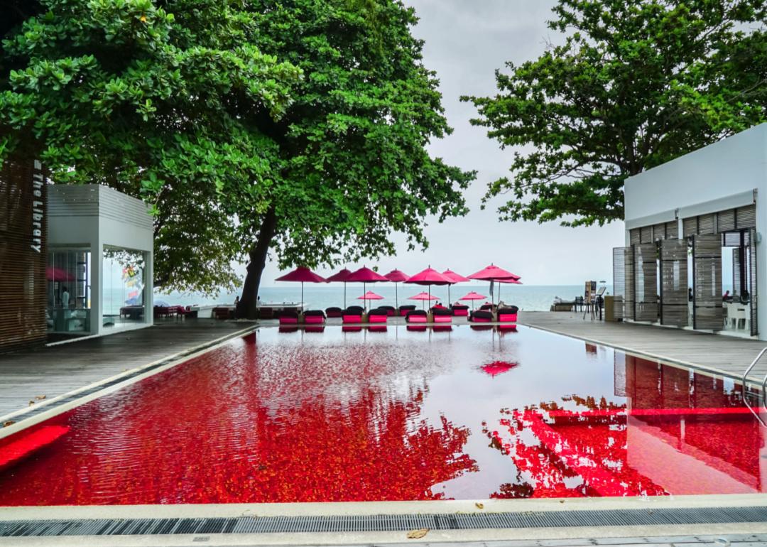 The swimming pool at The Library Koh Samui hotel, which looks like it is filled with blood red water.