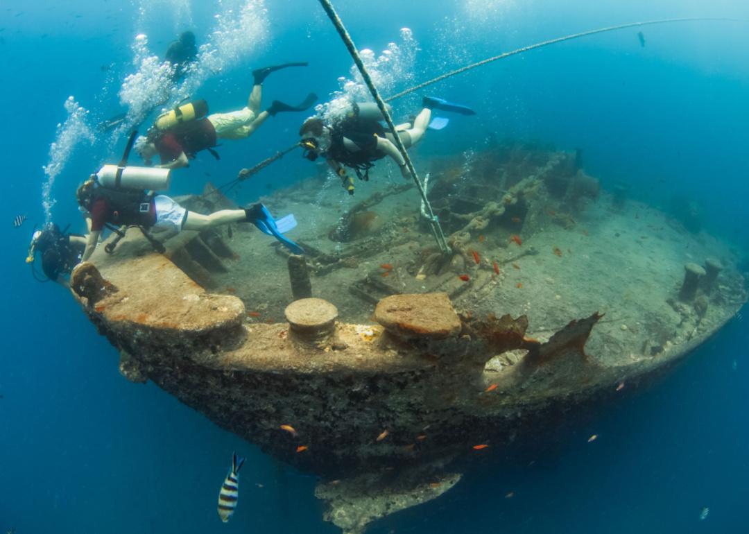 Scuba divers in the bow of the Thistlegorm shipwreck in the Red Sea.
