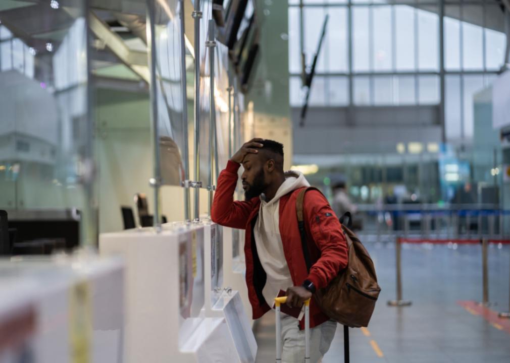 A frustrated man at an airline counter.