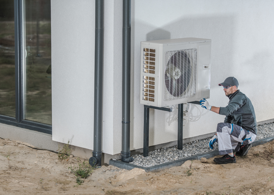 A worker installing a heat pump